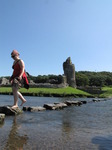 SX07975 Kristina crossing stepping stones at Ogmore Castle.jpg